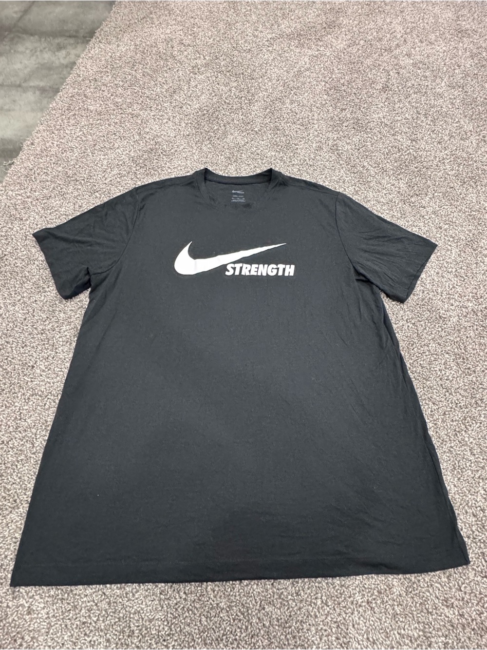 Nike Black Short Sleeve Tee with White Swoosh and "Strength"